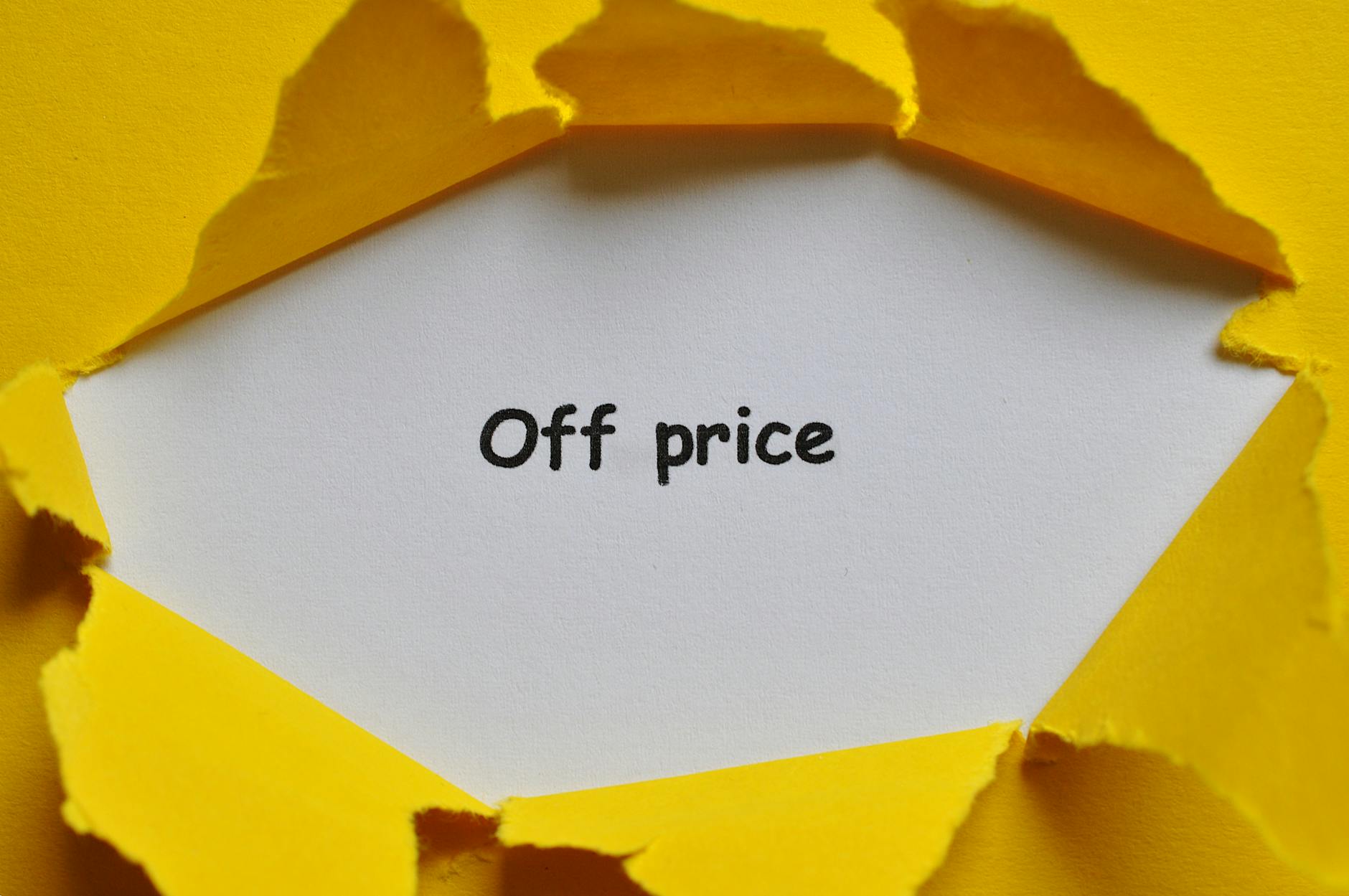 Yellow paper torn open to reveal 'Off Price' text, perfect for sales and discounts concept.